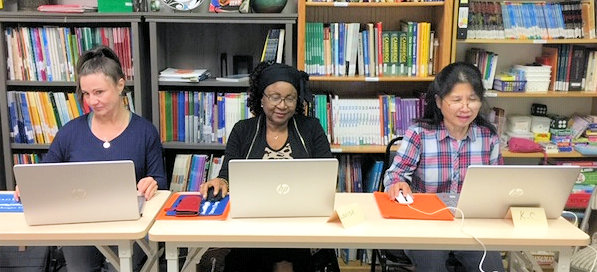 Three adults using their new computers